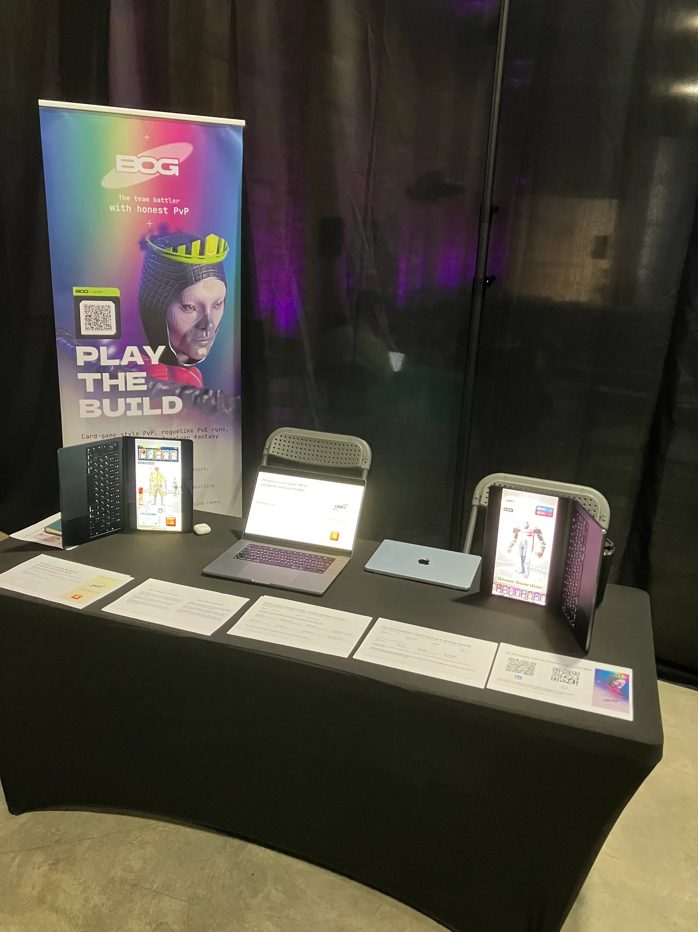 BOG’s StartupCon table with its banner, game displays and printed materials